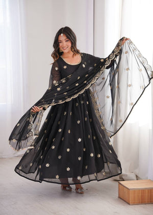 Jet Black Georgette Anarkali Suit with gold sequence embroidery and scalloped dupatta by The Beauty Queen Surat.