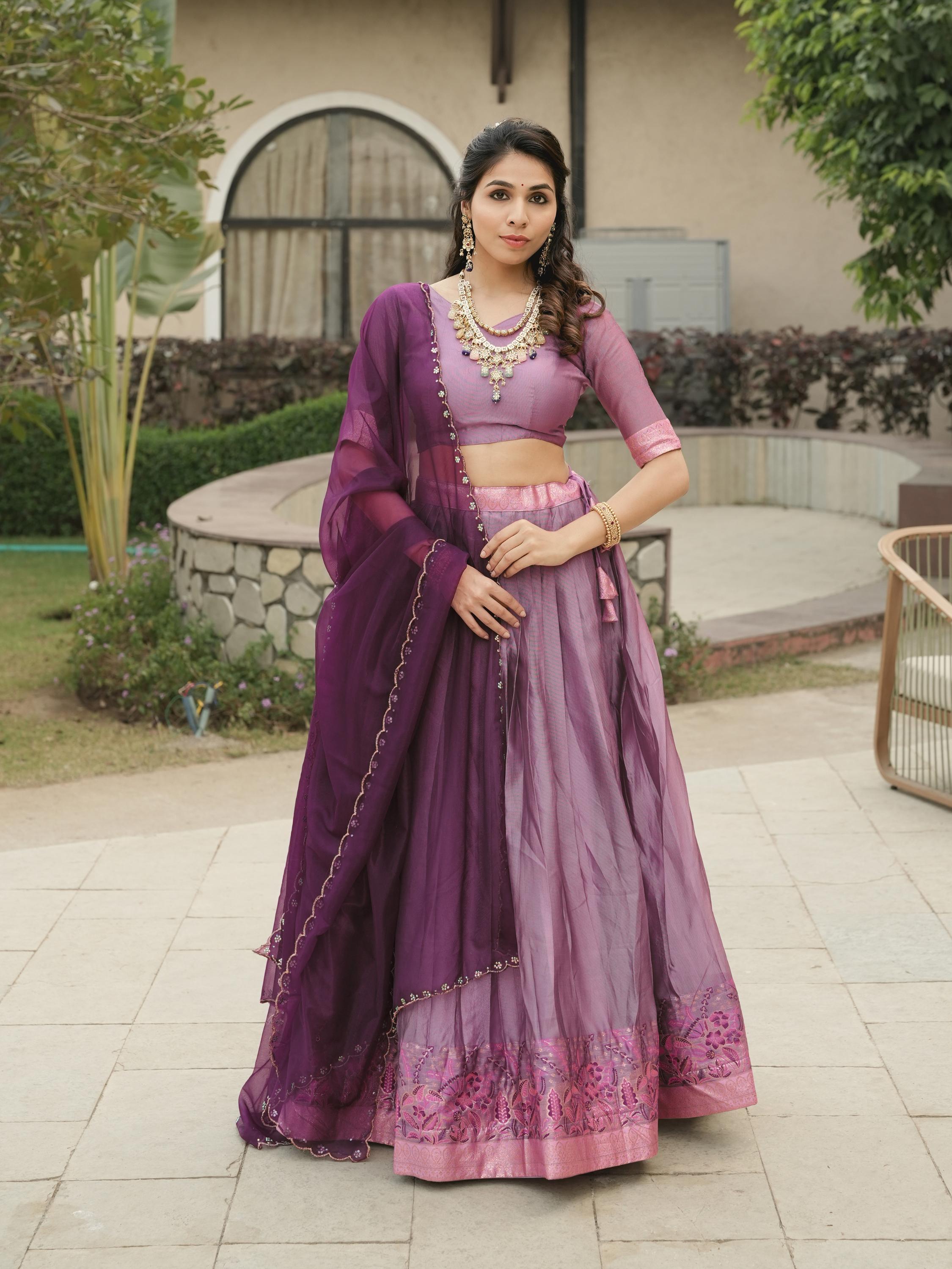 Lavender Shimmer Lehenga Choli featuring a rich magenta-gold zari weaving border paired with a contrasting deep purple scalloped dupatta by The Beauty Queen
