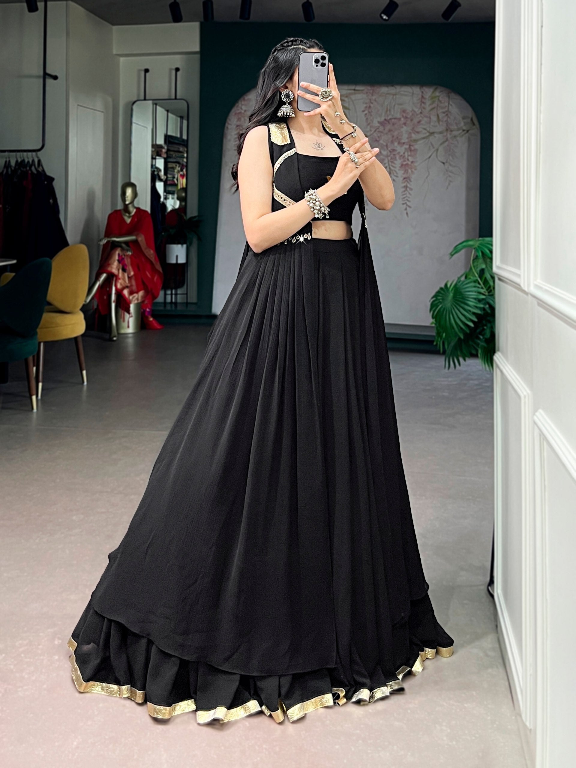 Model wearing Solid Jet Black Feather-Light Flow Fabric With Lotus Handwork & A Graceful Long Jacket Navratri Lehenga Choli Set by The Beauty Queen