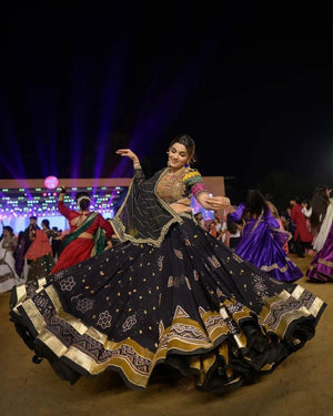 Model Dancing Garba In Black Heavy Muslin Cotton With Lampi Lace Border & Real Mirror Work Navratri Lehenga Choli Set By The Beauty Queen