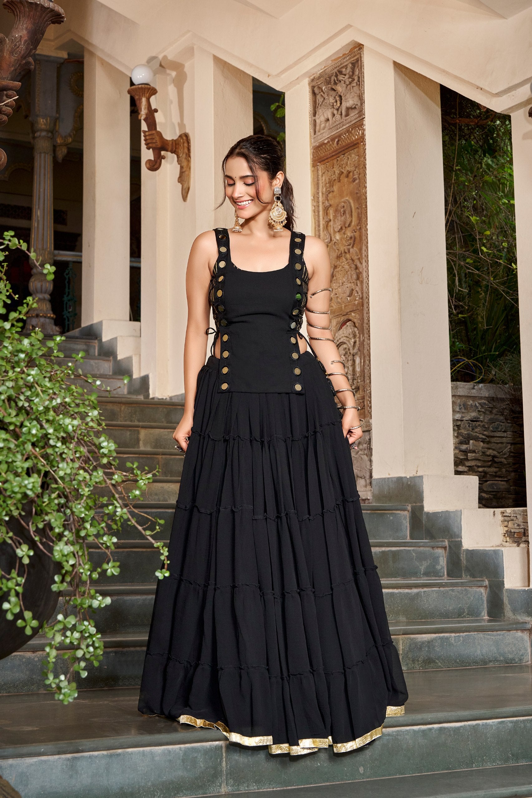 Model Wearing Black Lightweight Georgette Tiered Navratri Lehenga Choli Set With Mirror Details By The Beauty Queen