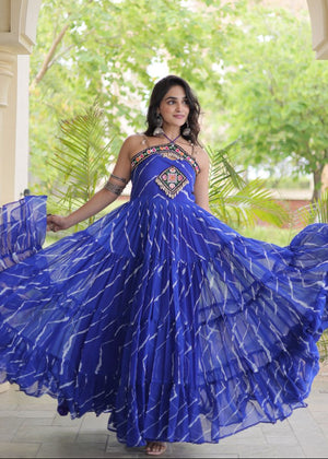 Model posing in Emerald Green Faux Georgette Leheriya Print Gown with Kutchi Patchwork and Cowrie Shell embellishments by The Beauty Queen