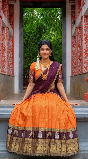 Bright Mango Orange and Dark Wine Gadwal Silk Weaving Zari Work South Indian Half Saree Langa Voni Set with Scallop Embroidery Lace Work flat lay view by The Beauty Queen
