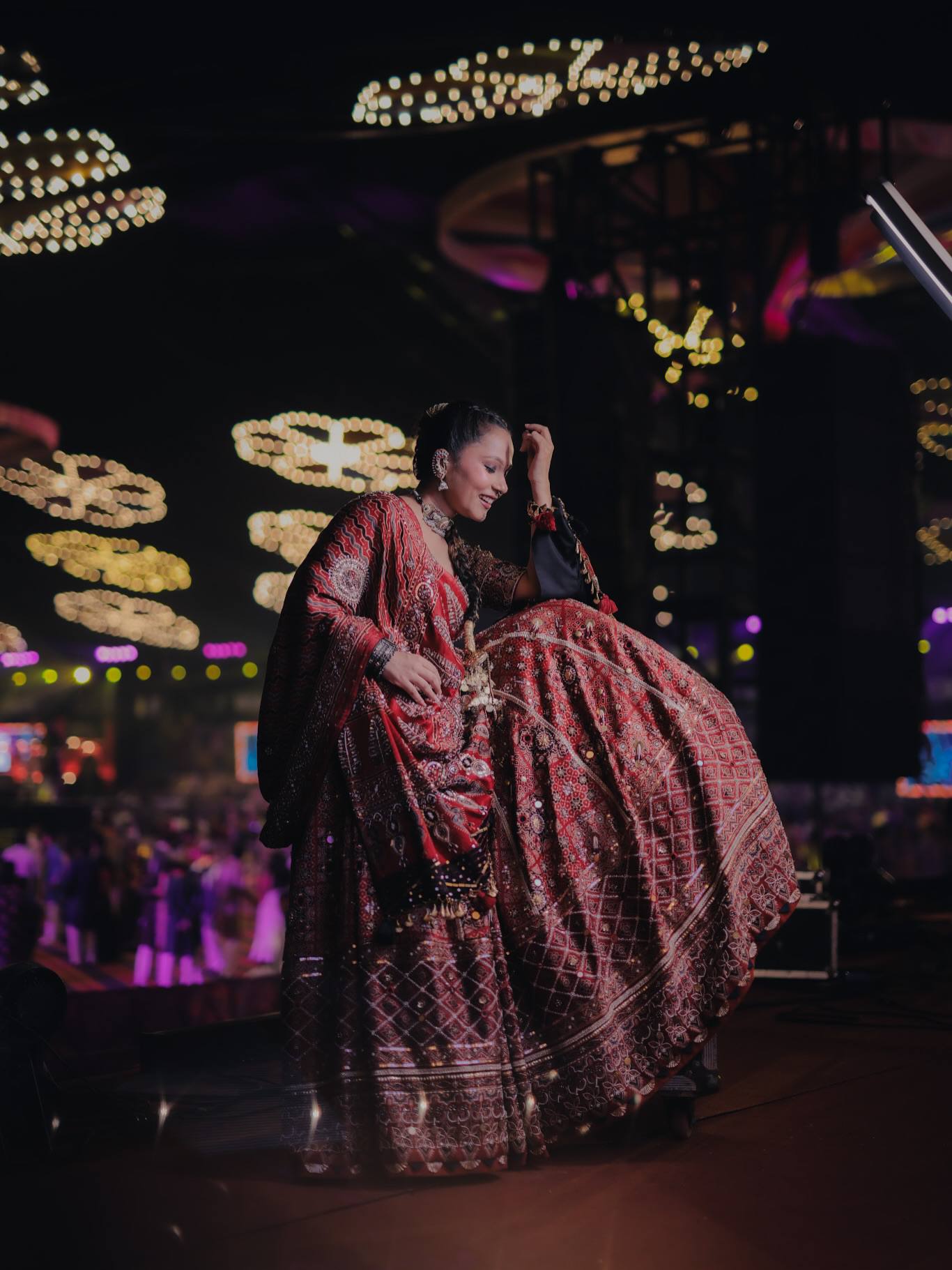 Model Posing On Stage In Maroon & Red Heavy Muslin Cotton With Canvas Patta Real Mirror Work Navratri Lehenga Choli Set By The Beauty Queen