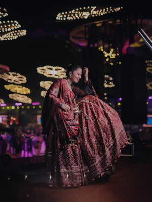 Model Posing On Stage In Maroon & Red Heavy Muslin Cotton With Canvas Patta Real Mirror Work Navratri Lehenga Choli Set By The Beauty Queen