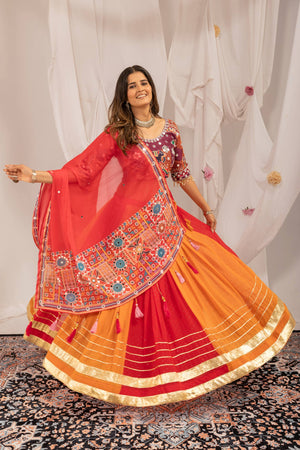 Model Twirling In Multi-Color Orange And Red Faux Georgette Hot Fix Diamond Navratri Lehenga Choli Set By The Beauty Queen