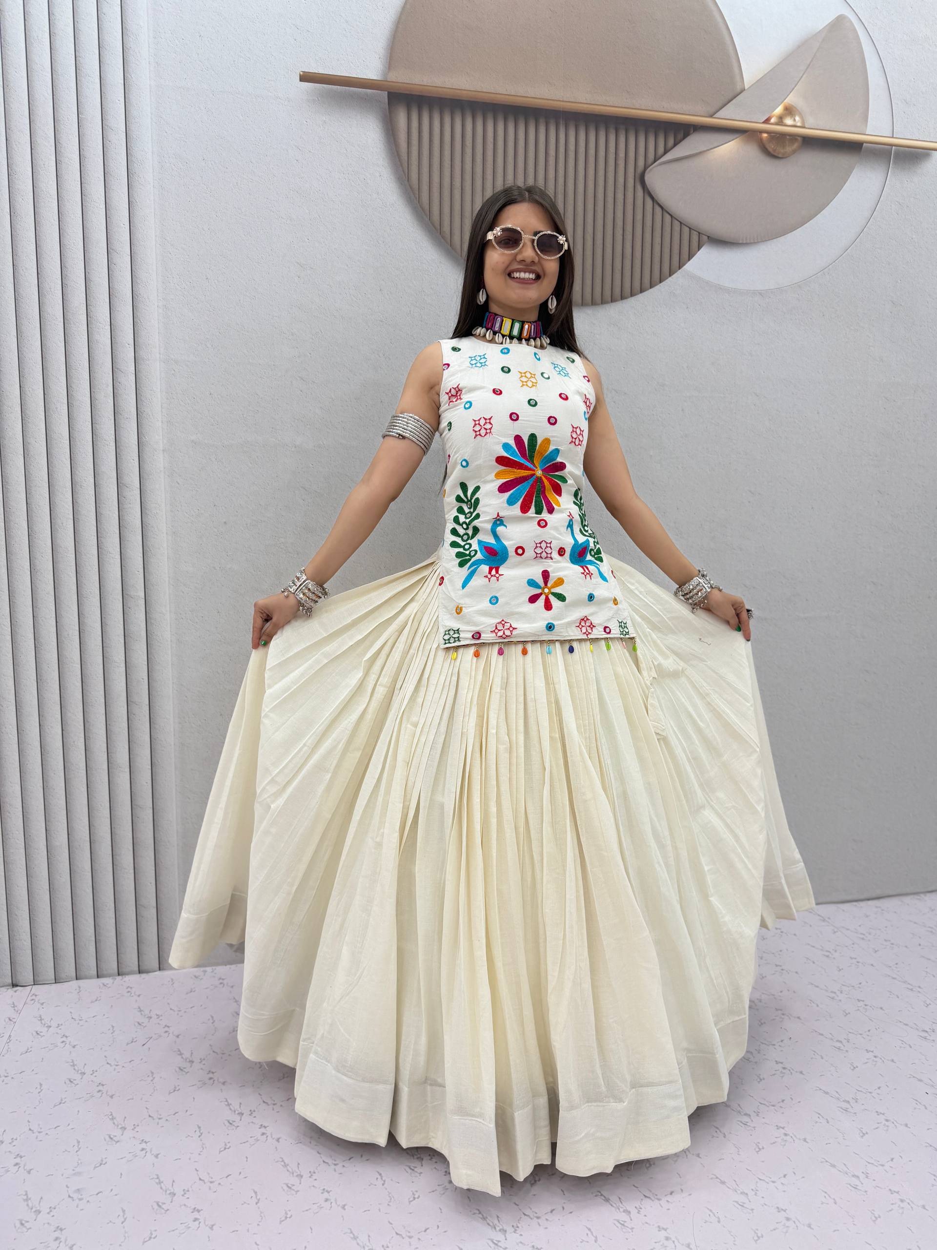 Model Posing Indoors Wearing Off-White Khadi Cotton Thread Work & Mirror Hand Work Navratri Lehenga Choli Set By The Beauty Queen