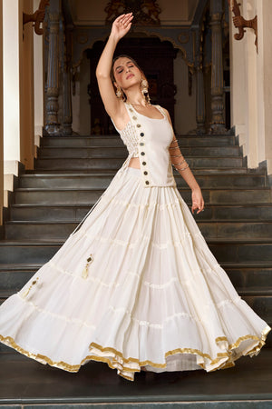 Model Twirling In Off White Lightweight Georgette Tiered Navratri Lehenga Choli Set With Mirror Accents By The Beauty Queen