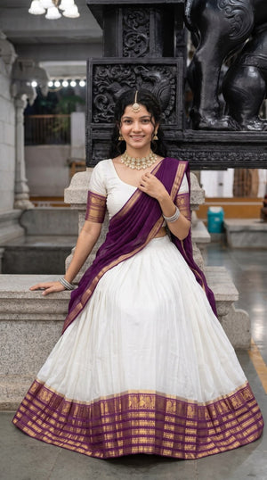 Off-White and Deep Plum Purple Mul Cotton Zari Weaving Work South Indian Half Saree Langa Voni Set flat lay view by The Beauty Queen
