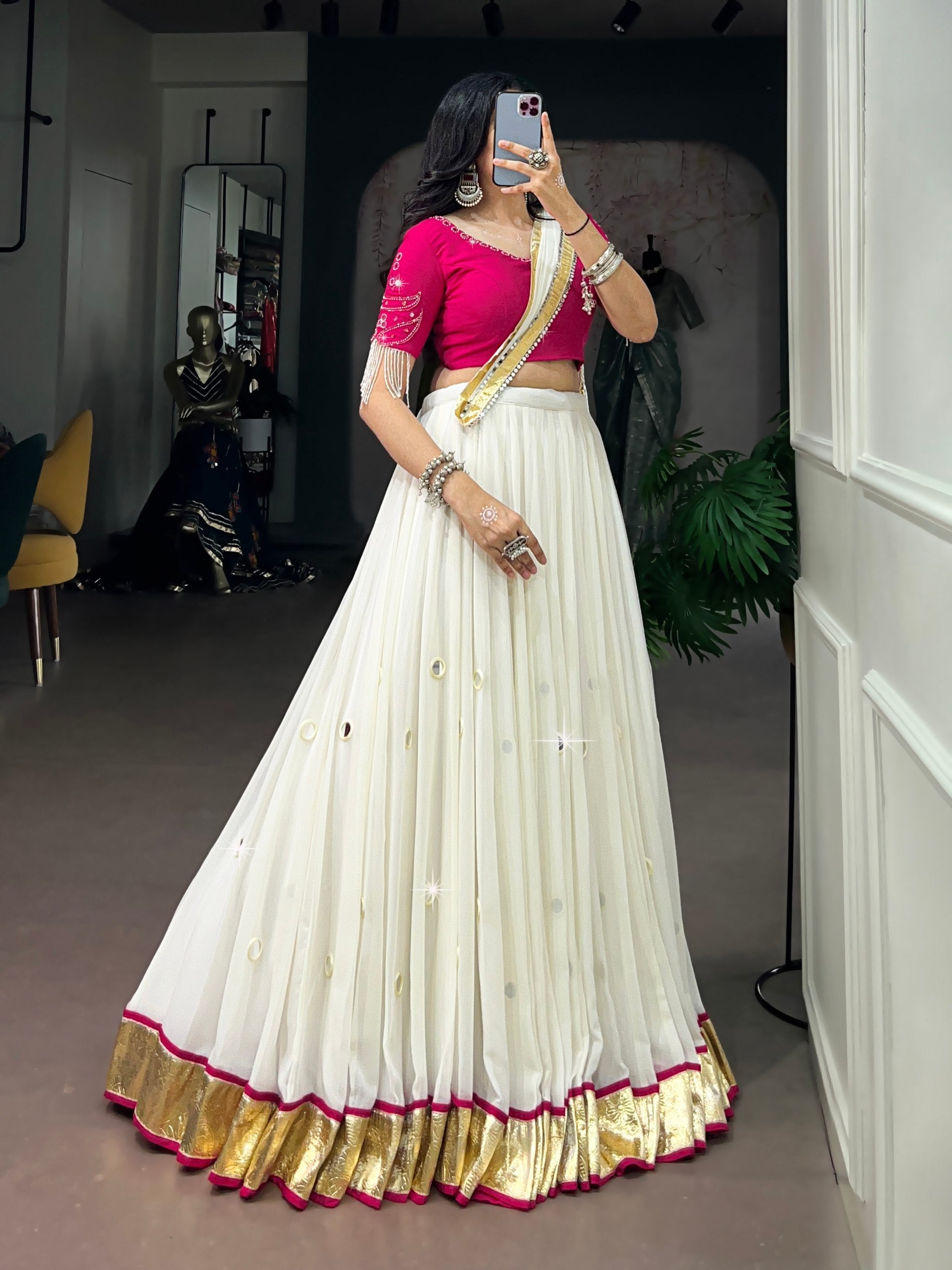 Model wearing Off-White & Rani Pink Lightweight Fabric With Embossed Design & Real Mirror Work Navratri Lehenga Choli Set by The Beauty Queen