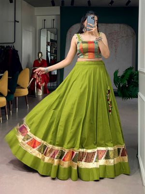 Model wearing Olive Green Cotton Lehenga Enhanced with Zari Weaving Embossed Design Work and Delicate Lace Touch-Up Navratri Chaniya Choli Set by The Beauty Queen