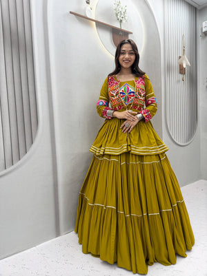 Model Posing Indoors Wearing Olive Green Pure Cotton Heavy Gamthi Work & Mirror Lace With Sikka Lace Navratri Lehenga Choli Set By The Beauty Queen