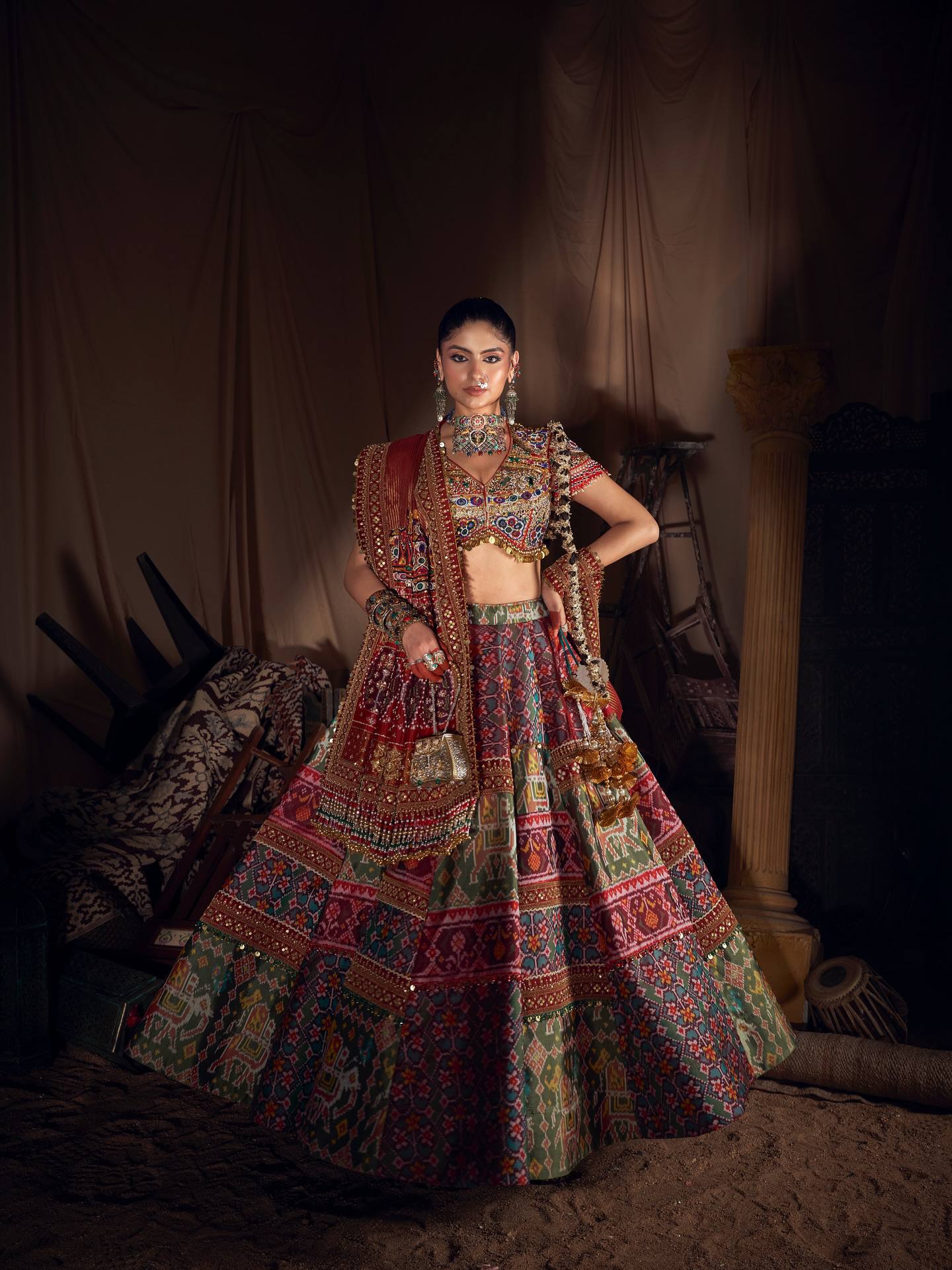 Model Posing In Studio Setting Wearing Multi-Color Patola Digital Print Heavy Muslin Cotton Real Mirror Work Navratri Lehenga Choli Set By The Beauty Queen