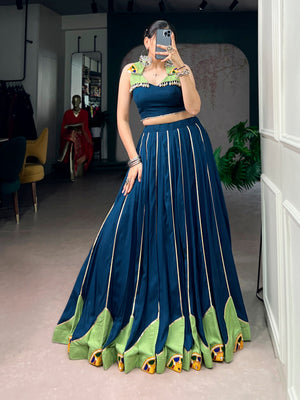 Model wearing Peacock Blue & Lime Green Rayon Fabric Lehenga Adorned With Traditional Gamthi Work, Gota Patti & Mirror Lace Navratri Chaniya Choli Set by The Beauty Queen
