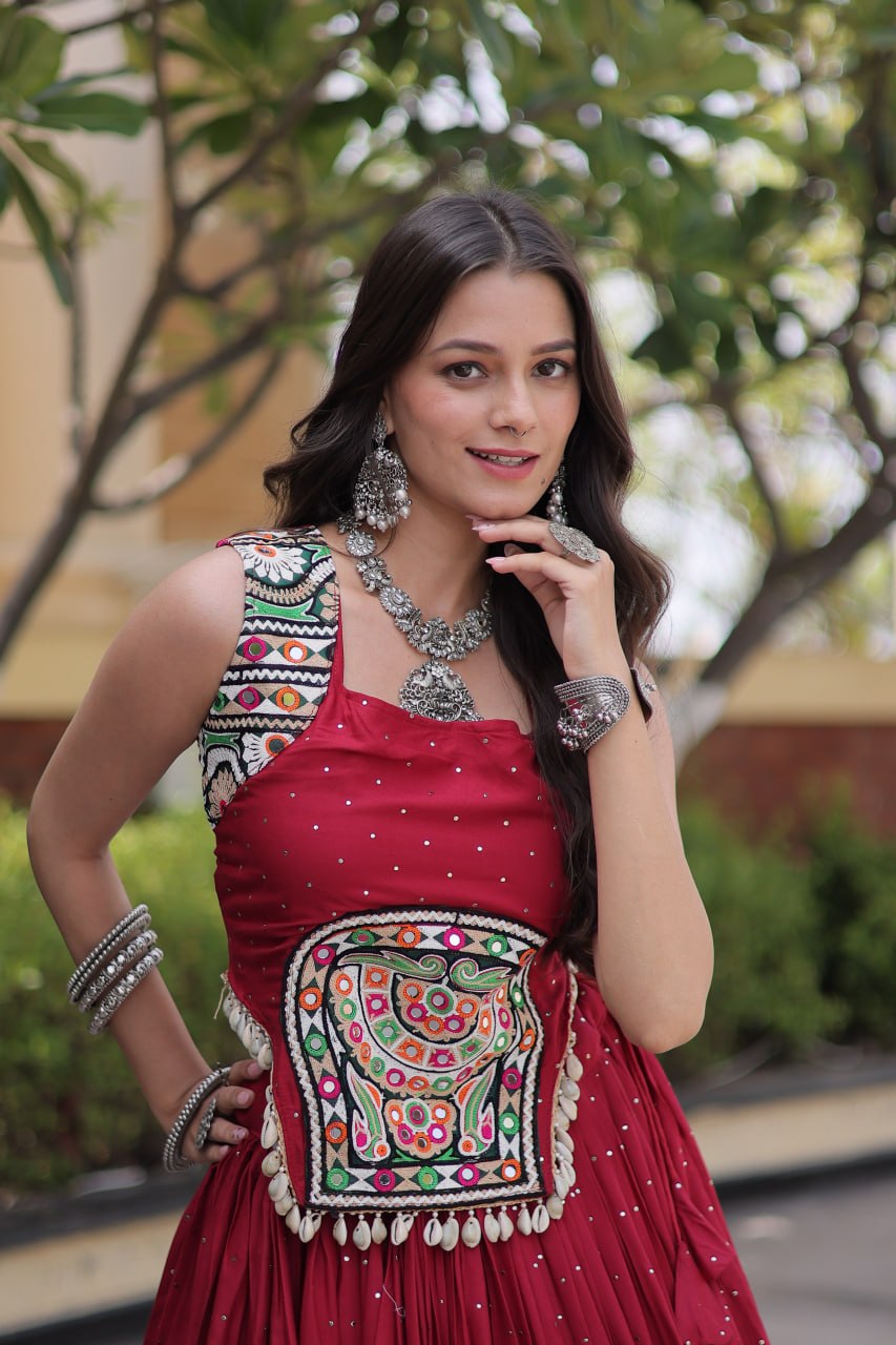 Maroon Crimson Red 14kg Rayon Navratri Special Flared Lehenga Choli Set with Sparkling Mukaish (Badla) Work, Multi-Line Gota Patti Borders & Kutchi Embroidered Cowrie Shell Sleeveless Blouse