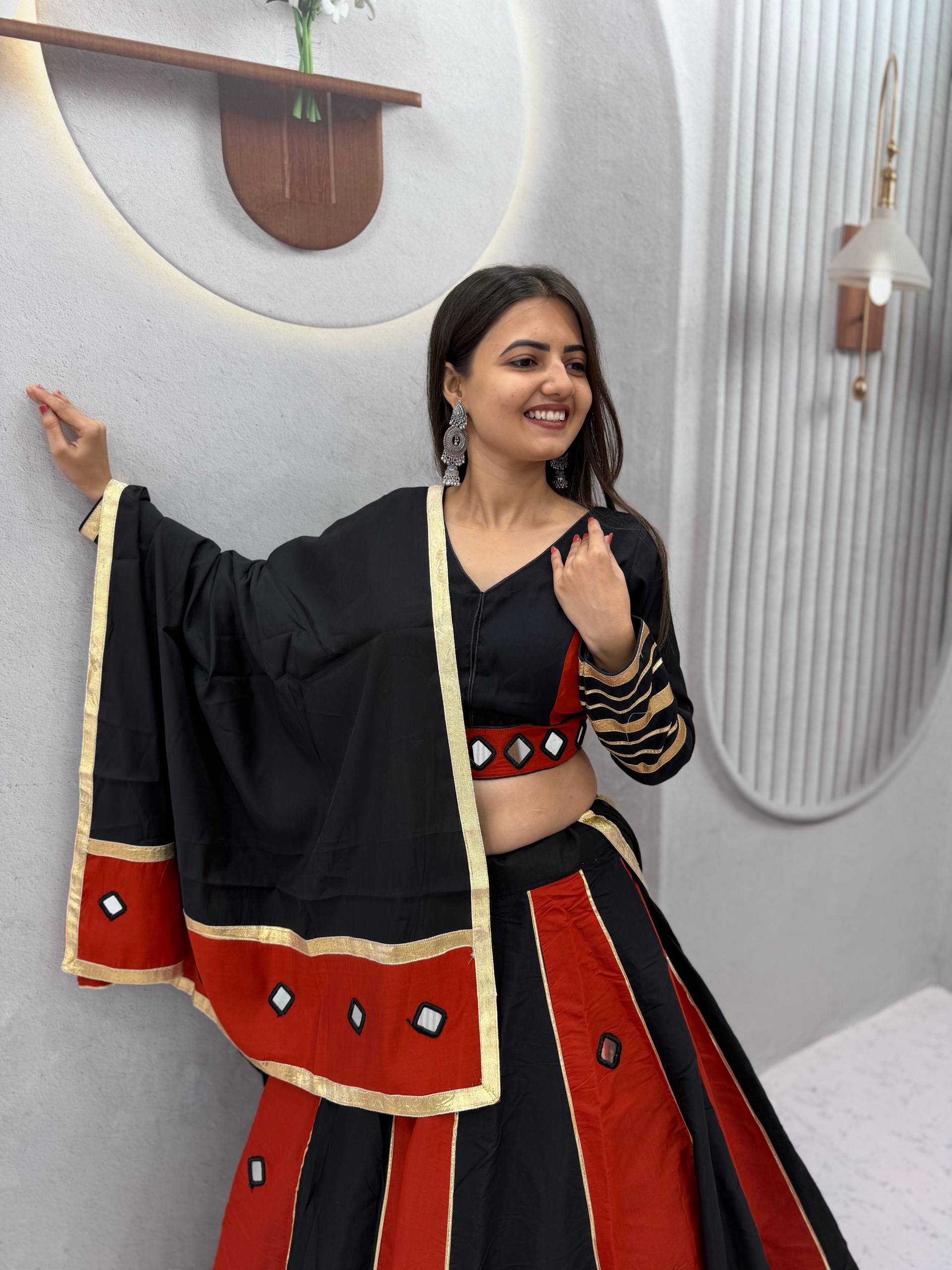 Jet Black & Rust Maroon Color-Blocked Roman Silk Navratri Special Flared Lehenga Choli Set with Real Mirror Work, Gold Gota Patti Borders, Full-Sleeve Blouse & Matching Dupatta