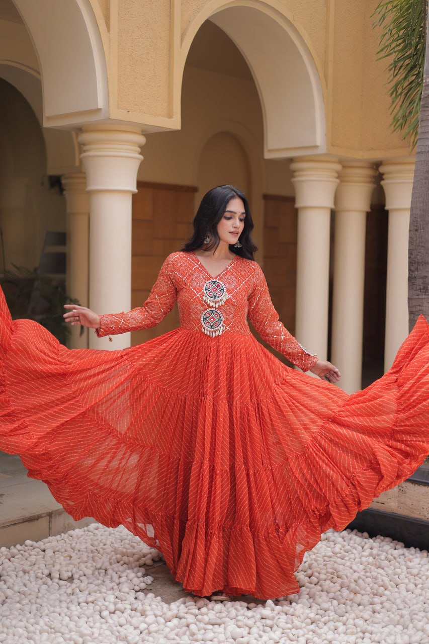 Rust Orange Laheriya Print Faux Georgette Tiered Anarkali Gown With Kutchi Patchwork & Shell Tassels Navratri Special Gown