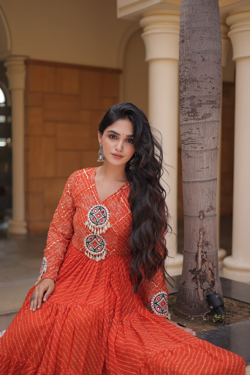 Rust Orange Laheriya Print Faux Georgette Tiered Anarkali Gown With Kutchi Patchwork & Shell Tassels Navratri Special Gown