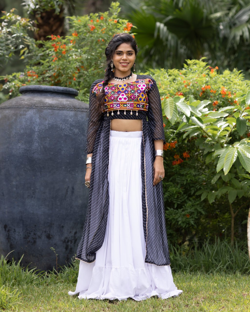 White pure rayon cotton plain frill pattern Navratri lehenga with micro cotton inner, black Kutchi mirror embroidered blouse with cowrie shells, and black leheriya long shrug