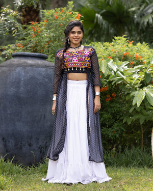 White pure rayon cotton plain frill pattern Navratri lehenga with micro cotton inner, black Kutchi mirror embroidered blouse with cowrie shells, and black leheriya long shrug