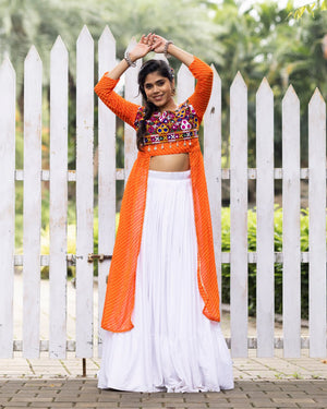 White pure rayon cotton plain frill pattern Navratri lehenga with micro cotton inner, orange Kutchi mirror embroidered blouse with cowrie shells, and leheriya long shrug