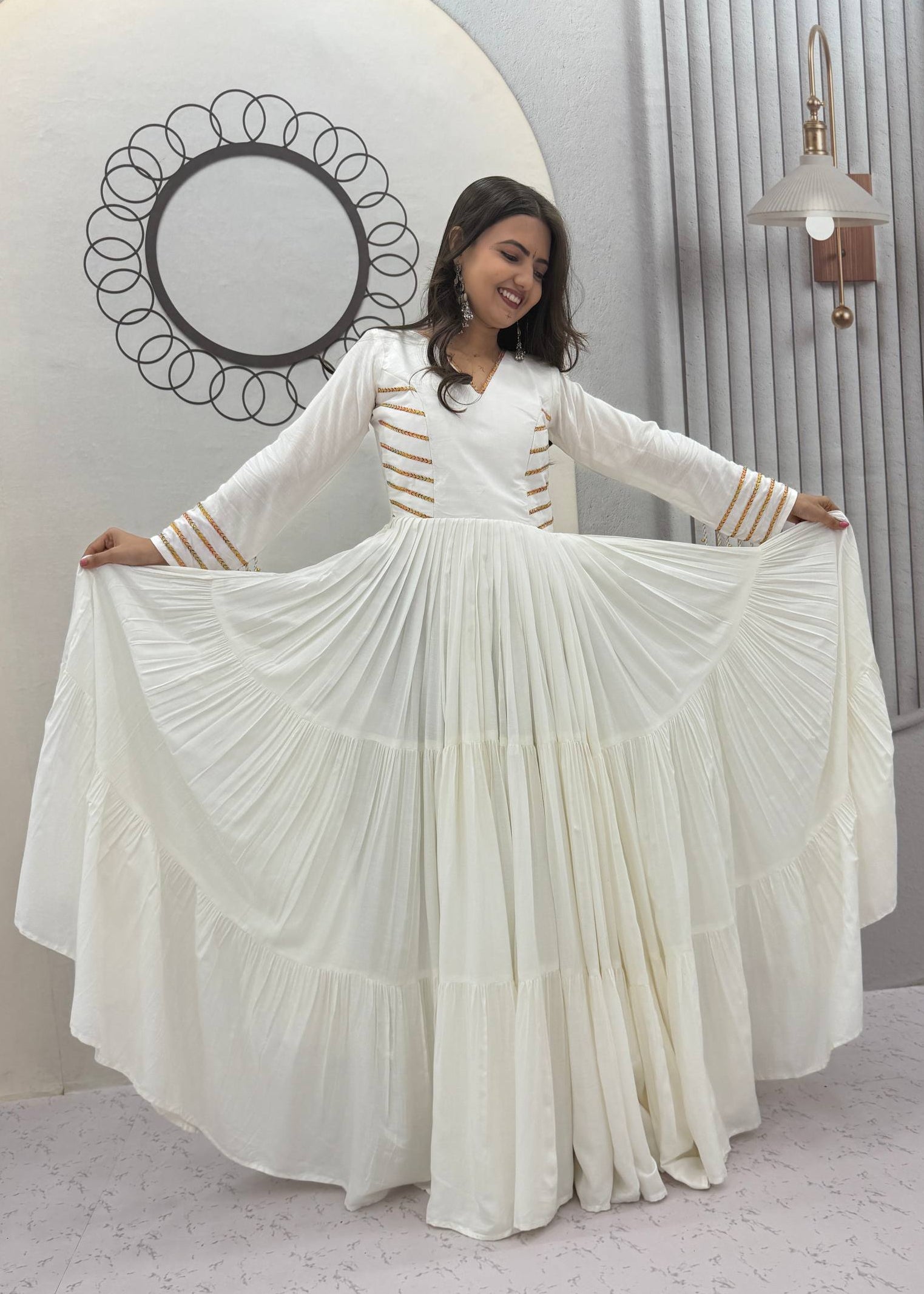 Off-White Pure Cotton Navratri Special Tiered Anarkali Gown with Gota Work and Hanging Tassels by The Beauty Queen