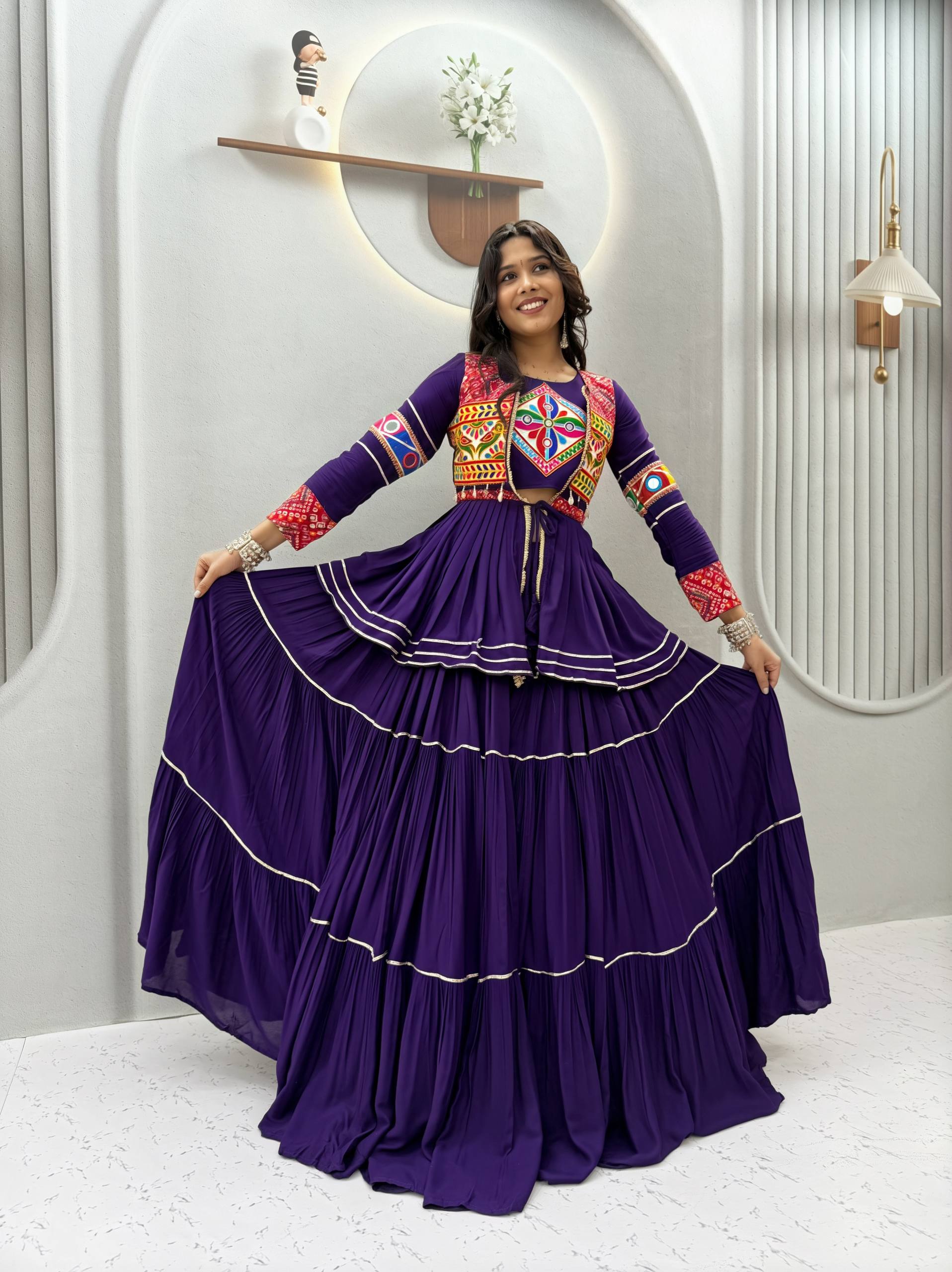 Model Posing Indoors Wearing Purple Pure Cotton Heavy Gamthi Work & Mirror Lace With Sikka Lace Navratri Lehenga Choli Set By The Beauty Queen