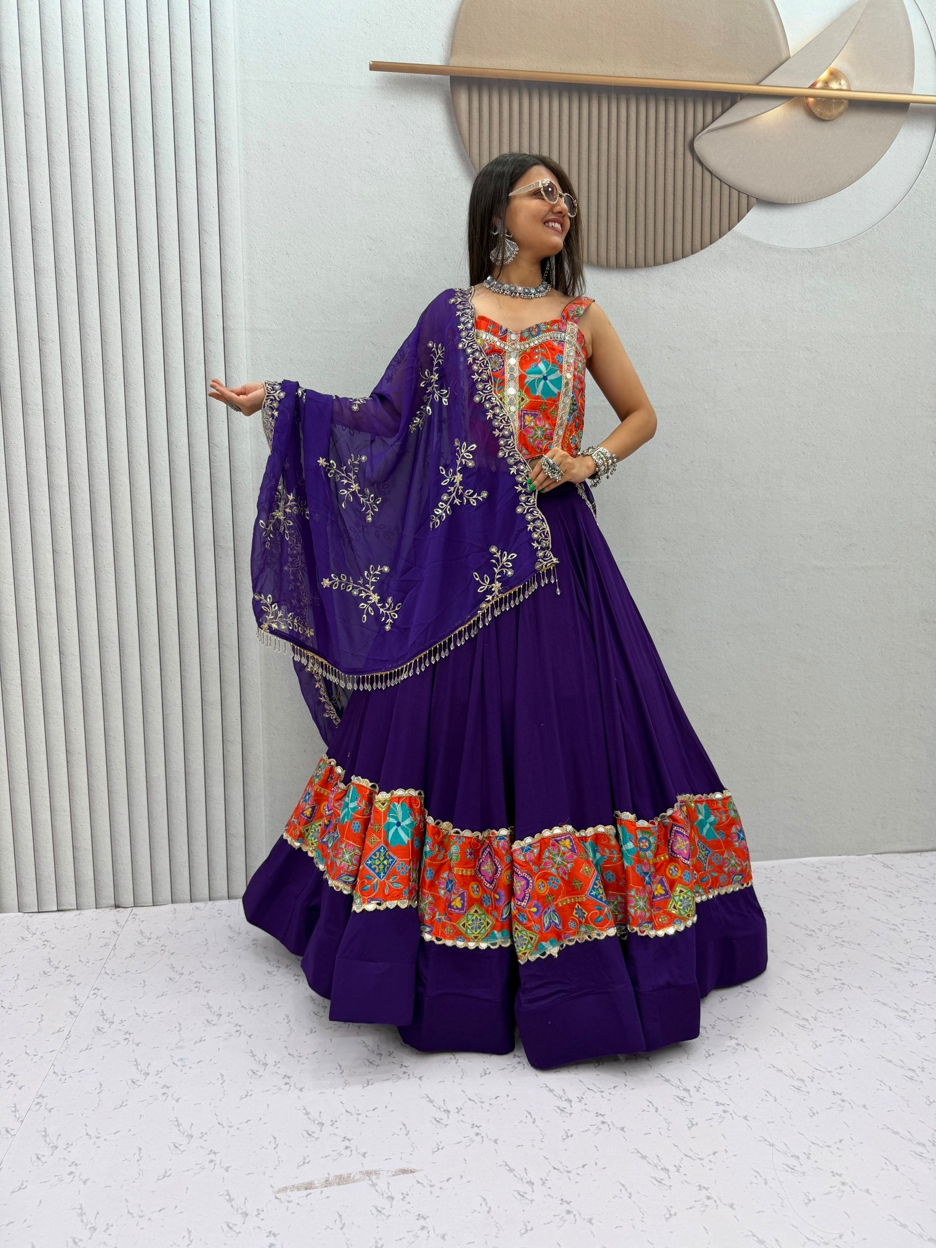 Model Posing Indoors Wearing Purple Pure Cotton Real Mirror Work Position Print Navratri Lehenga Choli Set By The Beauty Queen