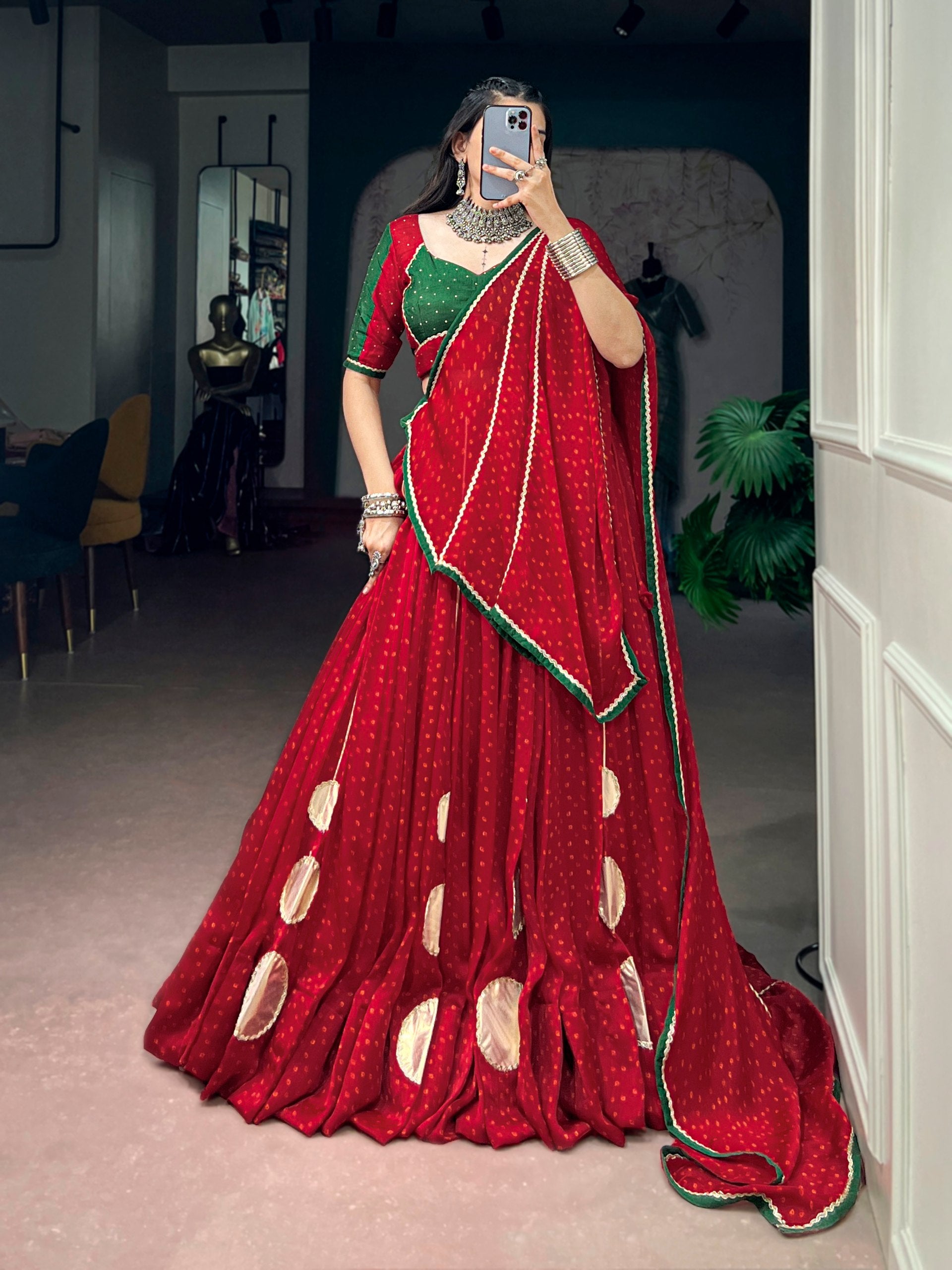 Model wearing Red & Green Bandhej Print On Satin Chiffon, Enhanced With Gotta Patch Work And A Beautifully Crafted Dola Silk Navratri Lehenga Choli Set by The Beauty Queen