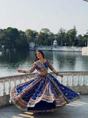 Model twirling outdoors in Royal Blue Heavy Muslin Cotton Beautiful Digital Print & Real Mirror Work Navratri Lehenga Choli Set by The Beauty Queen