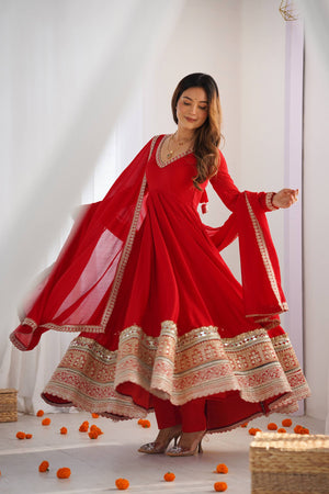 Model twirling in a Sindoor Red Heavy Pure Blooming Vichitra Silk Fully Flared Anarkali Gown Suit Set with Golden Zari Border by The Beauty Queen
