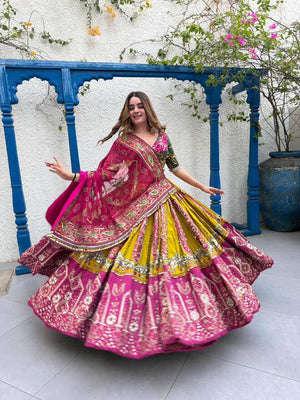 Model Twirling Outdoors In Yellow & Rani Pink Heavy Muslin Cotton Beautiful Digital Print & Real Mirror Work Navratri Lehenga Choli Set By The Beauty Queen